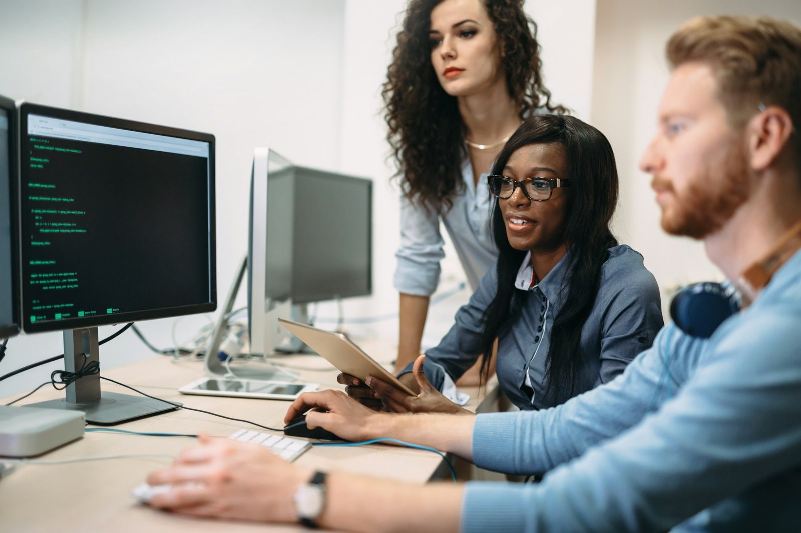Programmers cooperating at information technology company Programmers cooperating at information technology company